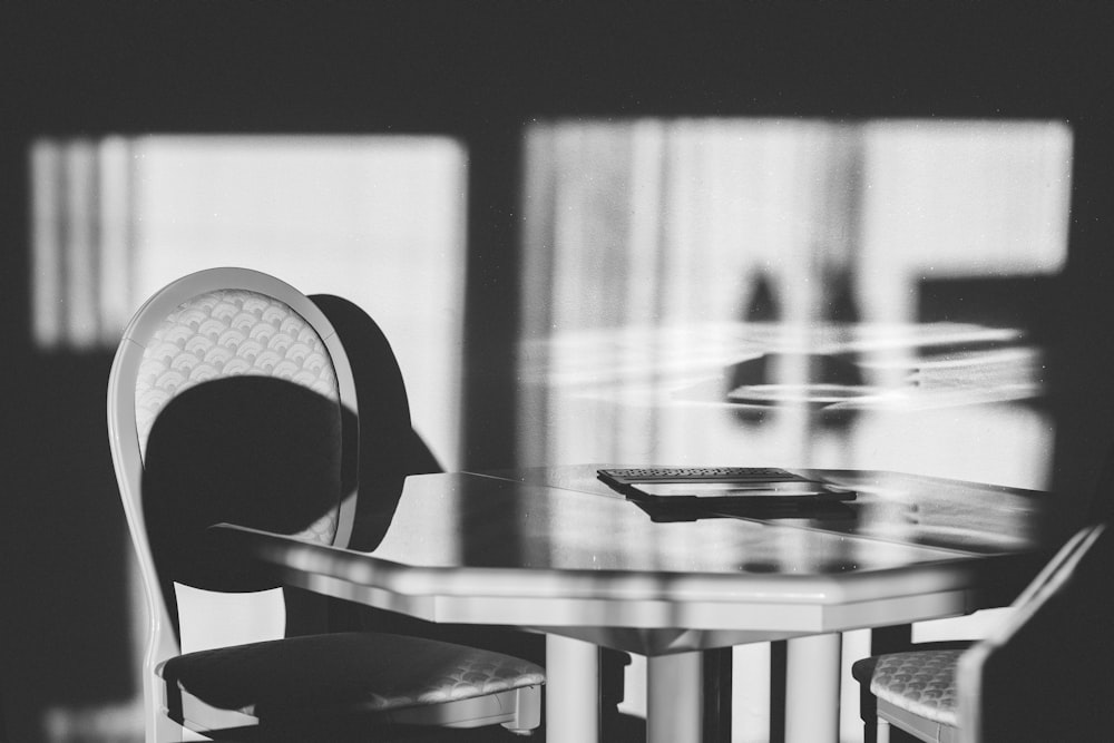 grayscale photography of table and chair