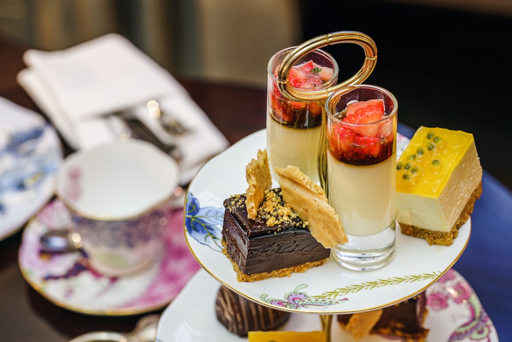 sliced cakes and drinks on white plate