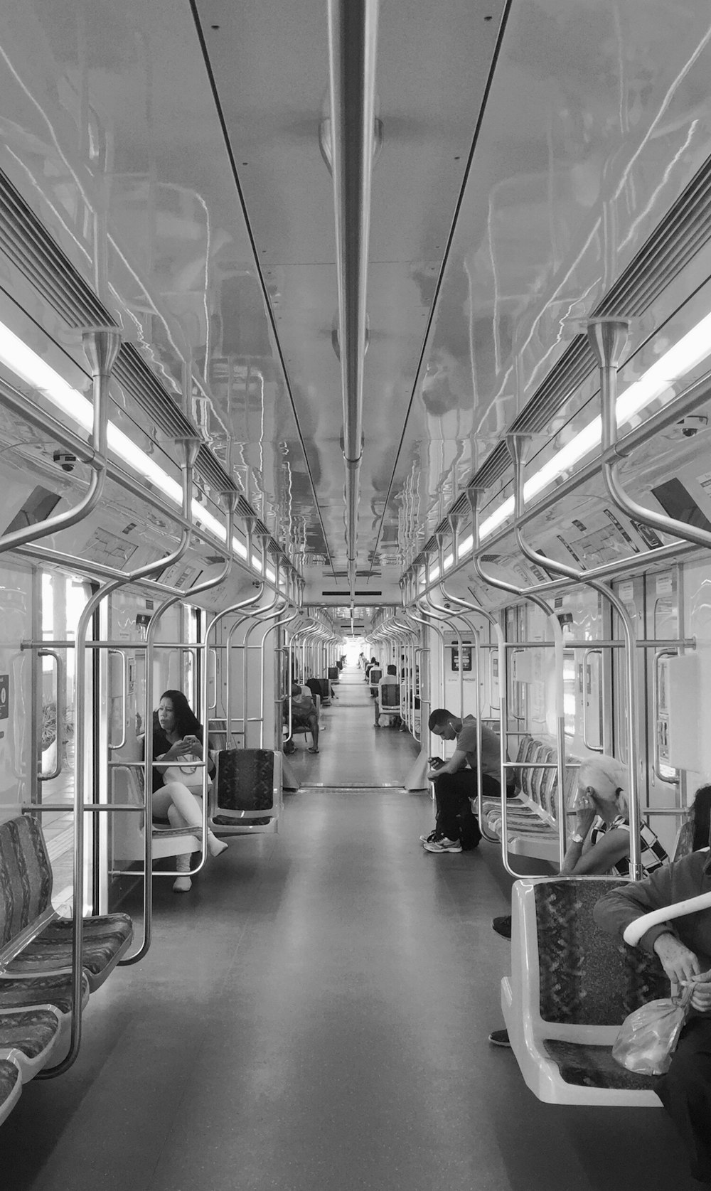 grayscale photography of few people inside train