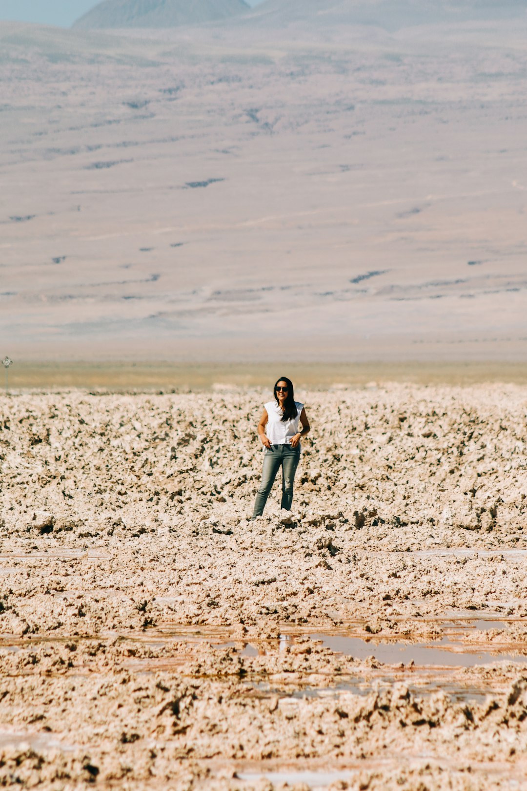 woman standing on mud during daytime