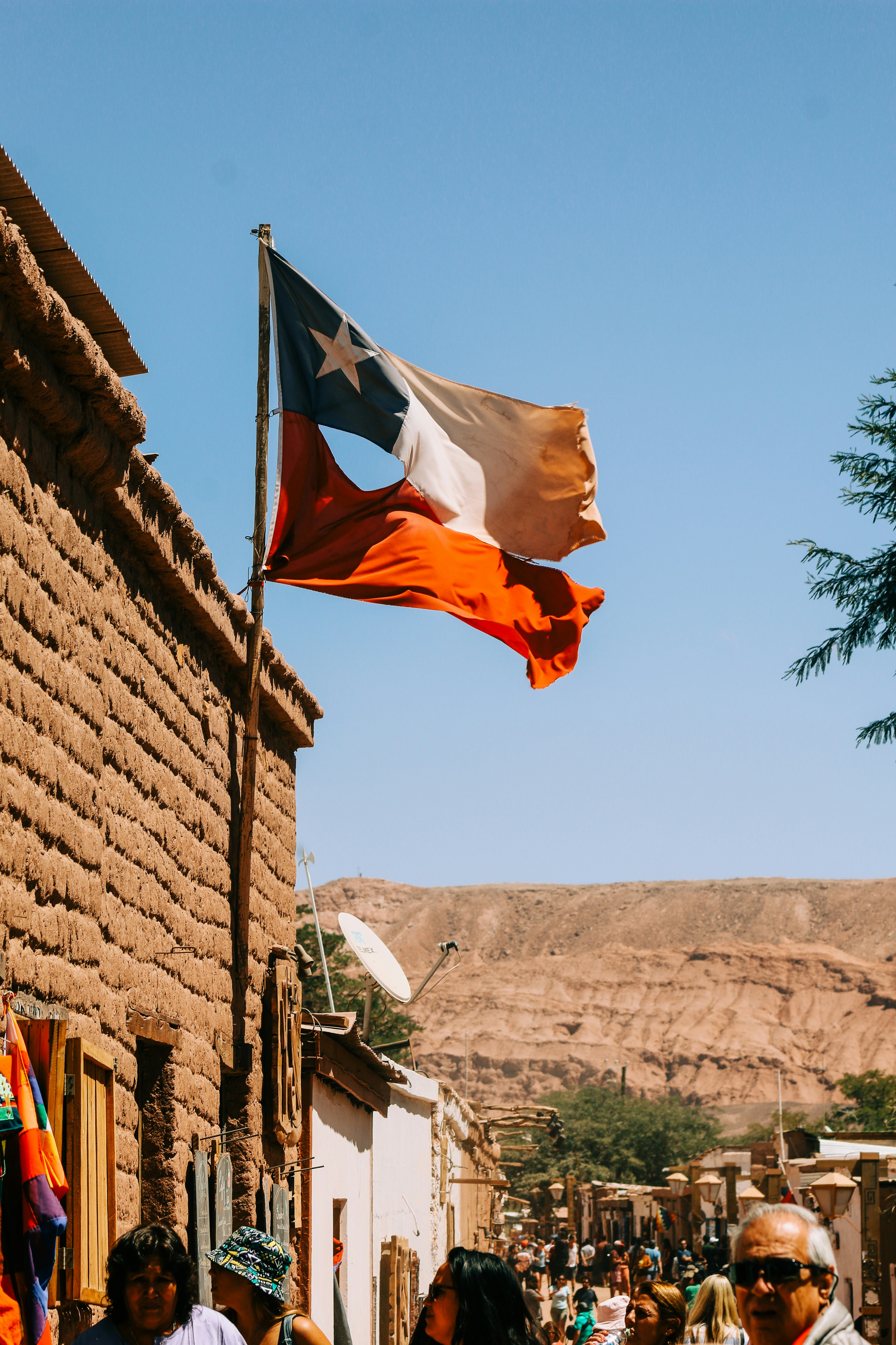 People walking near building and Chile flag waving photo – Free Chile ...