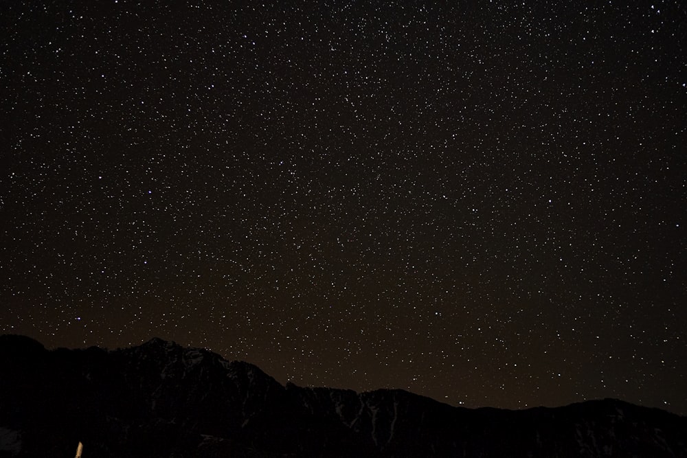 silhouette of mountain during night time