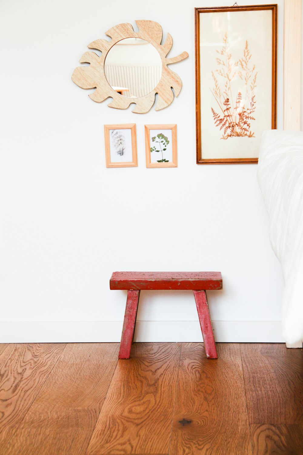 brown wooden bench against white wall