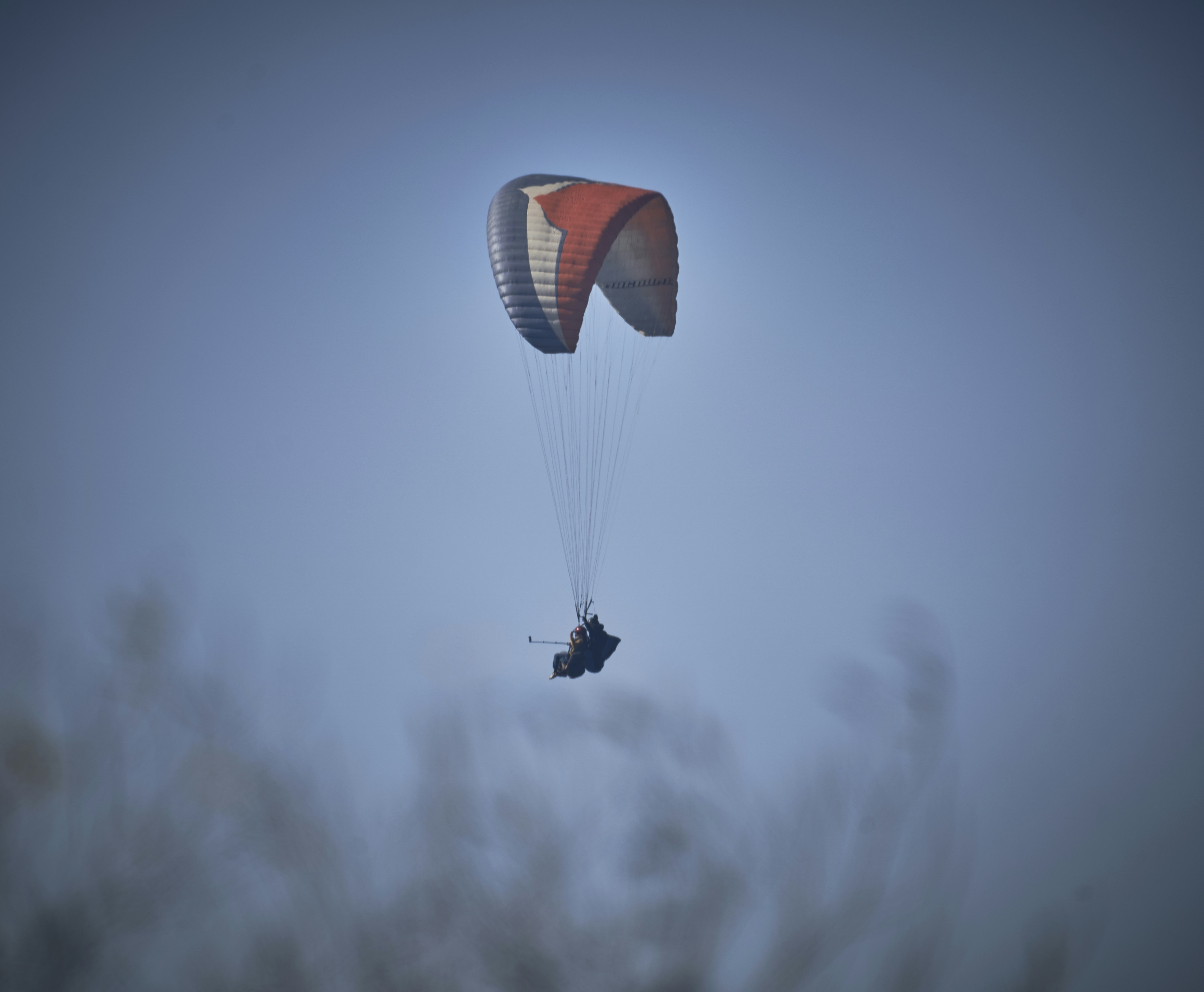 shallow focus photo of white and red parachute