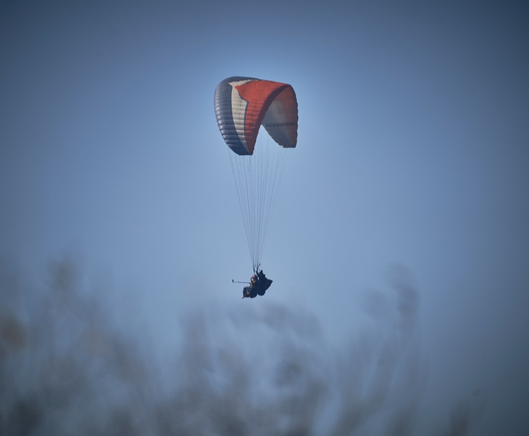 shallow focus photo of white and red parachute