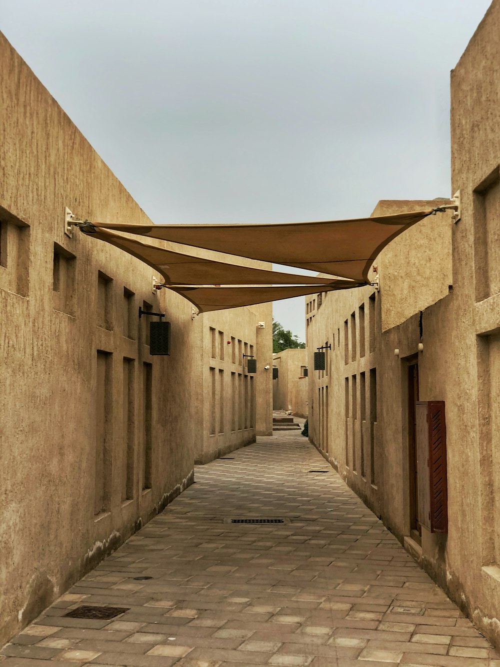 empty street between gray concrete buildings