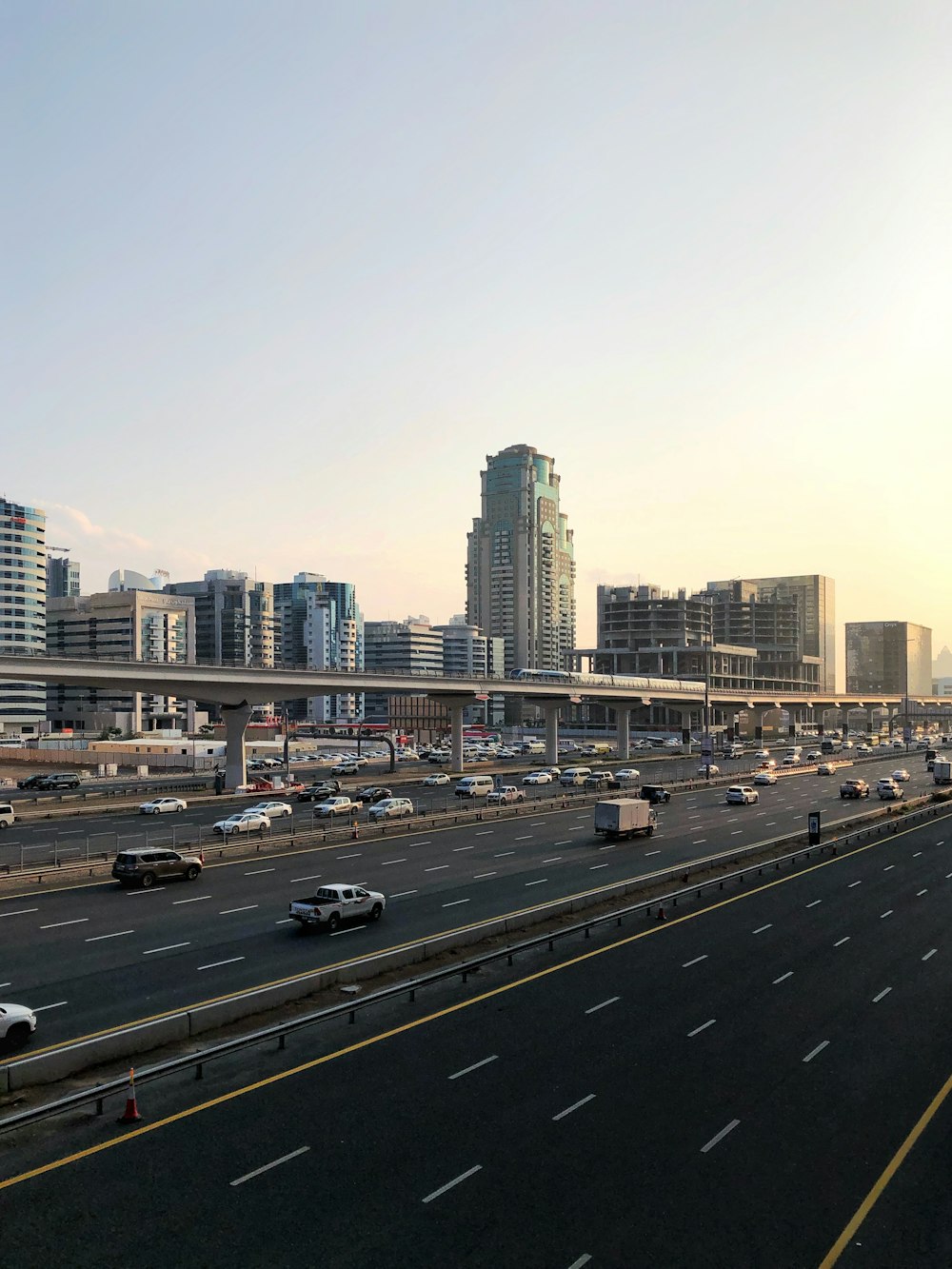 vehicles on road in front of high-rise buildings