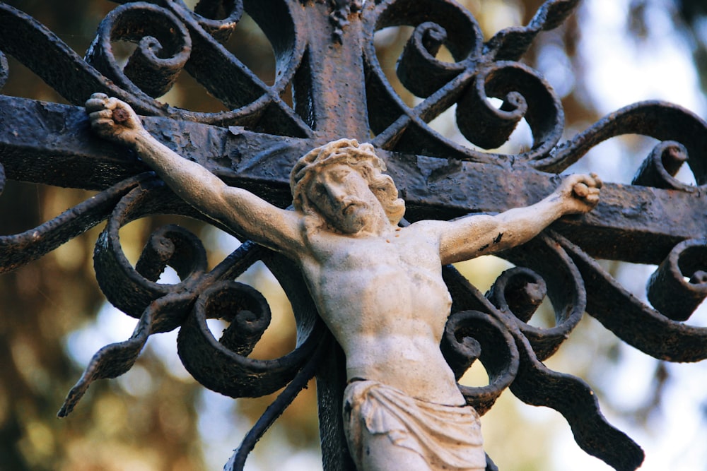 shallow focus photo of crucifix figurine