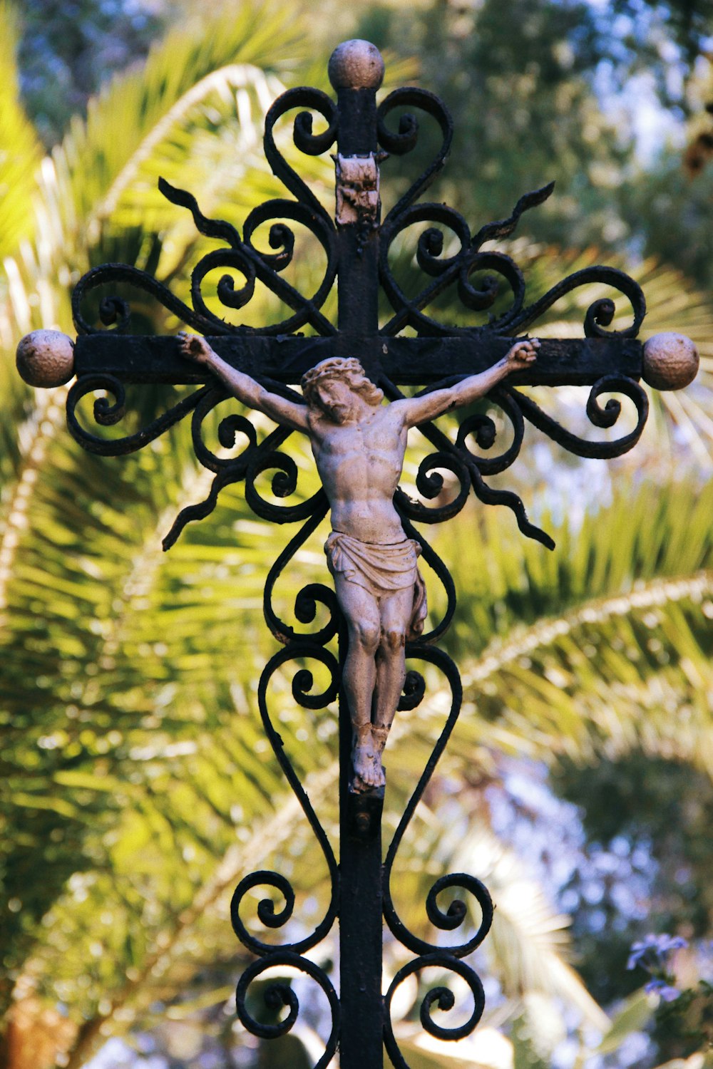 shallow focus photo of crucifix figurine