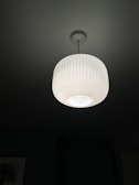 A modern ceiling lamp illuminating a stylish living room.