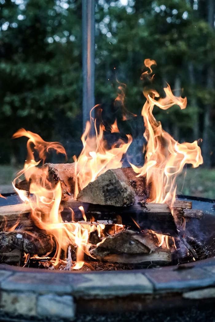 Circular dry-stack stone fire ring corbelled cap with decomposed granite pad surround