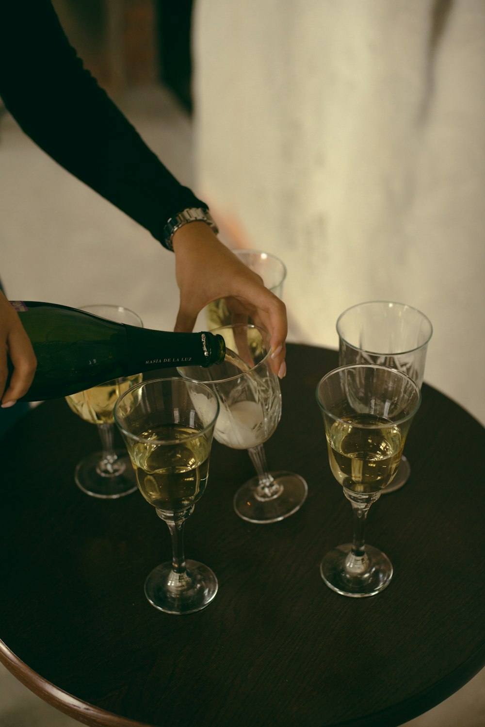 shallow focus photo of clear footed wine glasses on black table