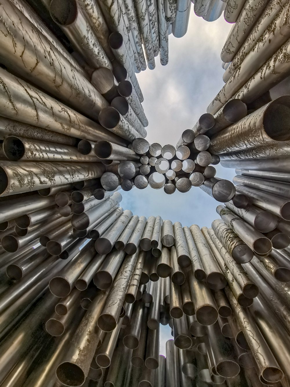 low-angle photo of pipes under blue sky