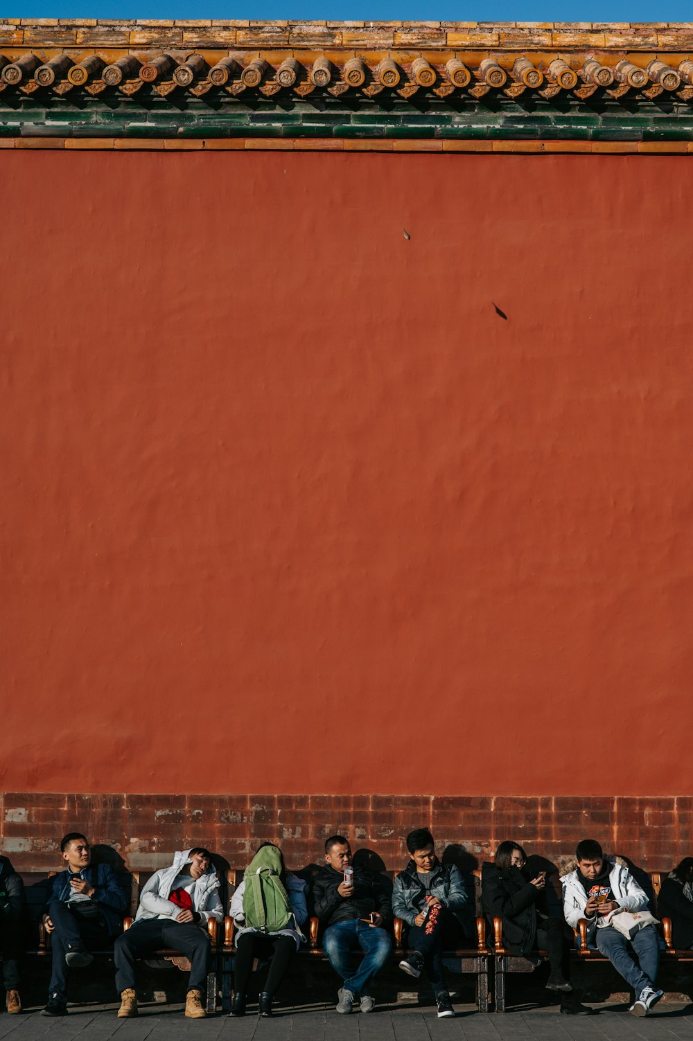 man sitting beside the wall