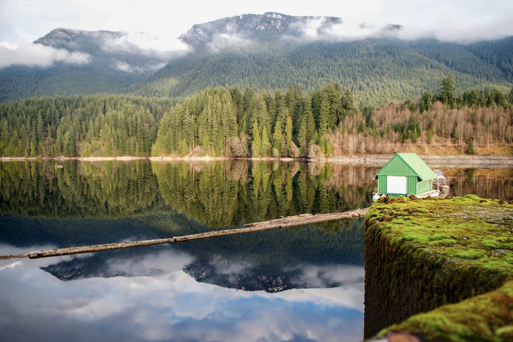 green house beside body of water