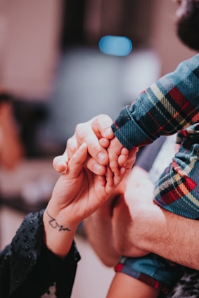 a couple holding hands while holding each other