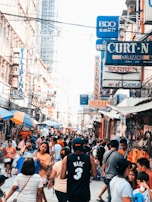 A colorful market street bustling with local vendors and tourists.