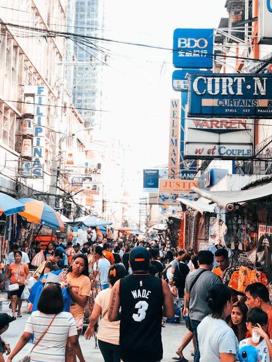 A vibrant marketplace scene filled with colorful products and busy shoppers.