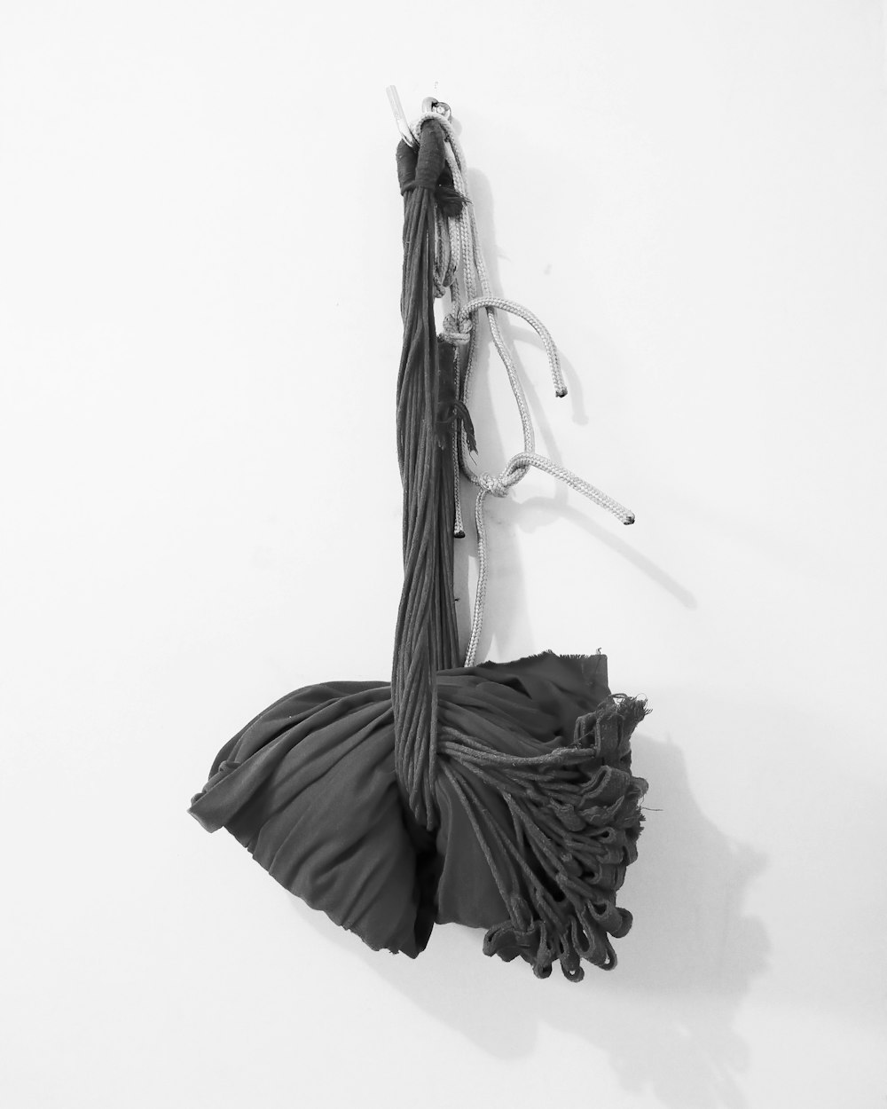 grayscale photography of a shawl hanging on wall
