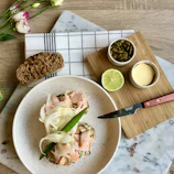 Freshly prepared Scandinavian-style dish on a rustic wooden table, bathed in natural light.