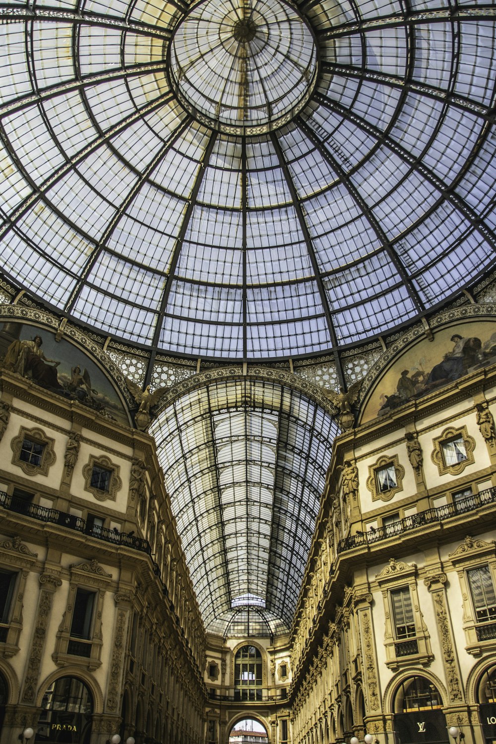 low-angle photography of glass dome building ceiling