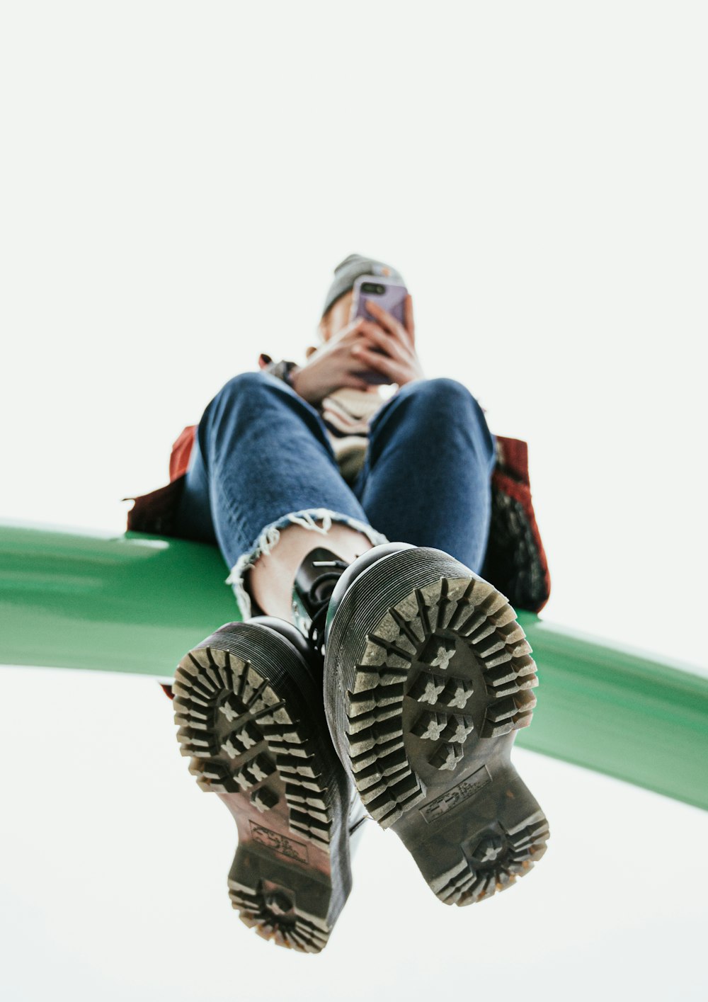 woman sitting on pole