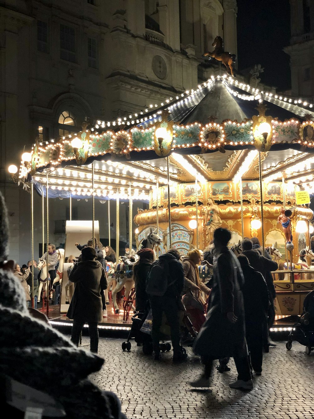 people near horse carousel