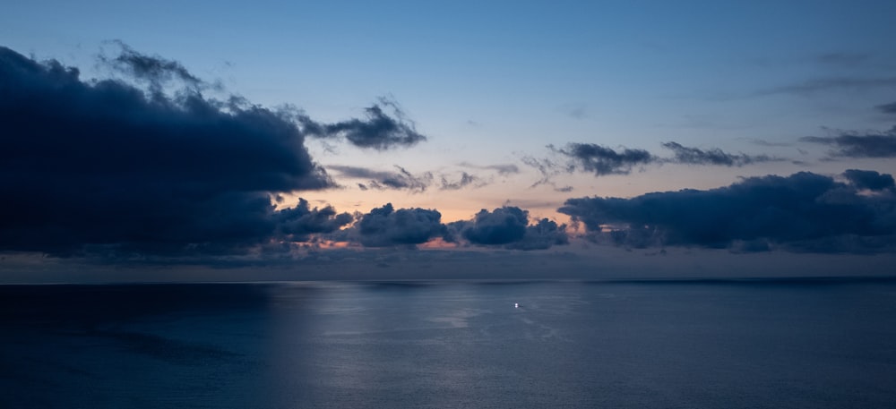 a large body of water under a cloudy sky