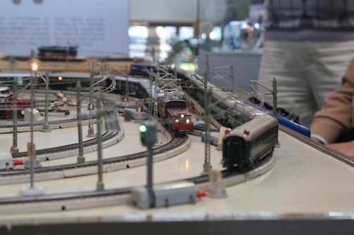a man playing with a large model railway set