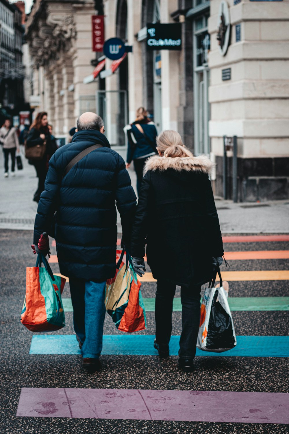 man and woman crossing road