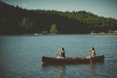 two persons on boat canoe zoom background