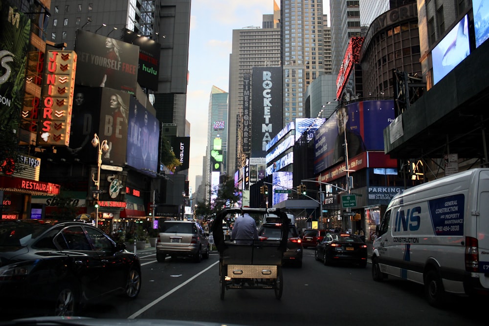 vehicles on road near city buildings during daytime