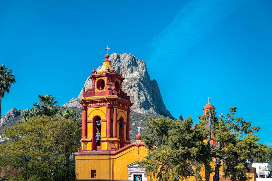 yellow and brown basilica viewing mountain under blue sky