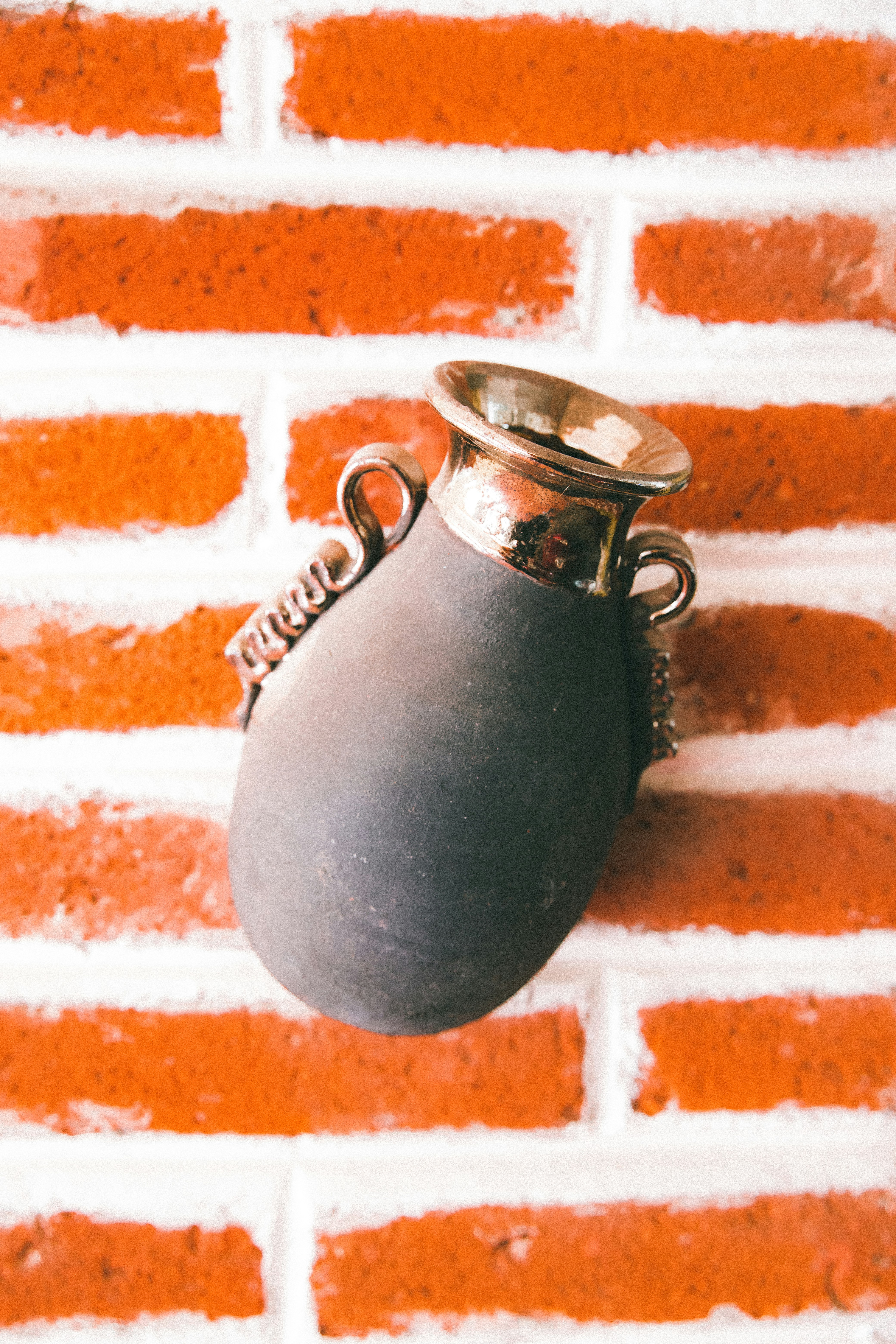 grey stainless steel vase on brown surface