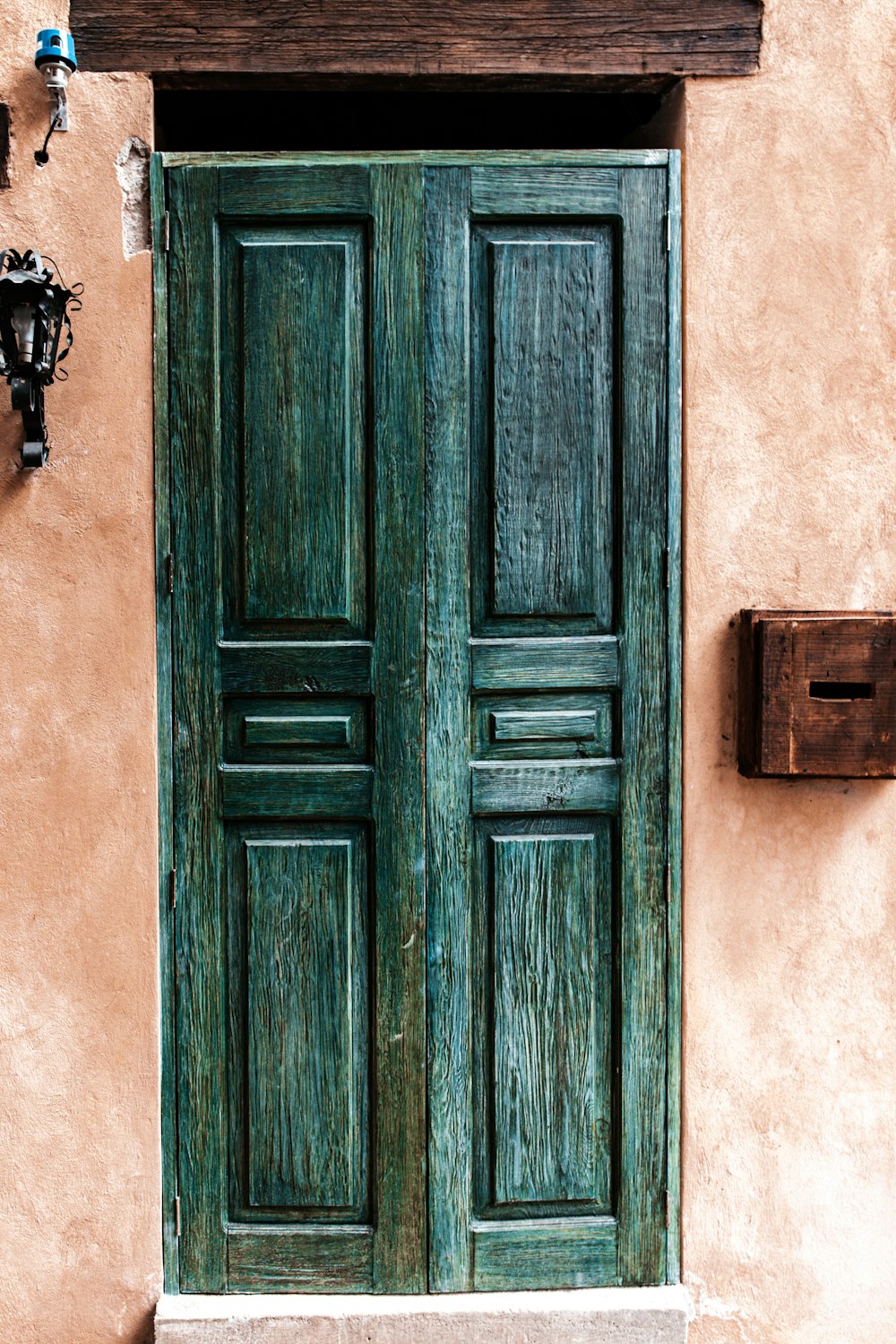 closed green wooden 6-panel door