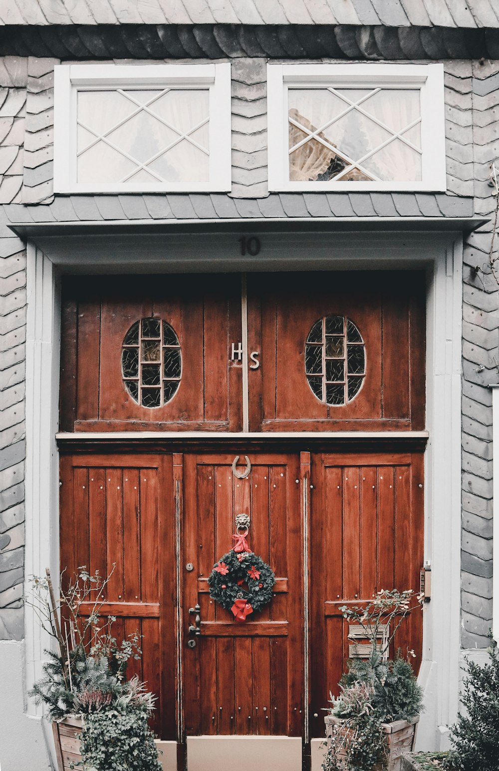 a wooden door with a wreath on it