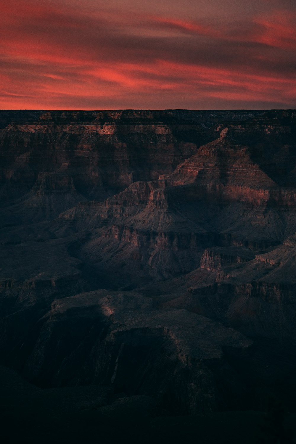 badlands under reddish sky