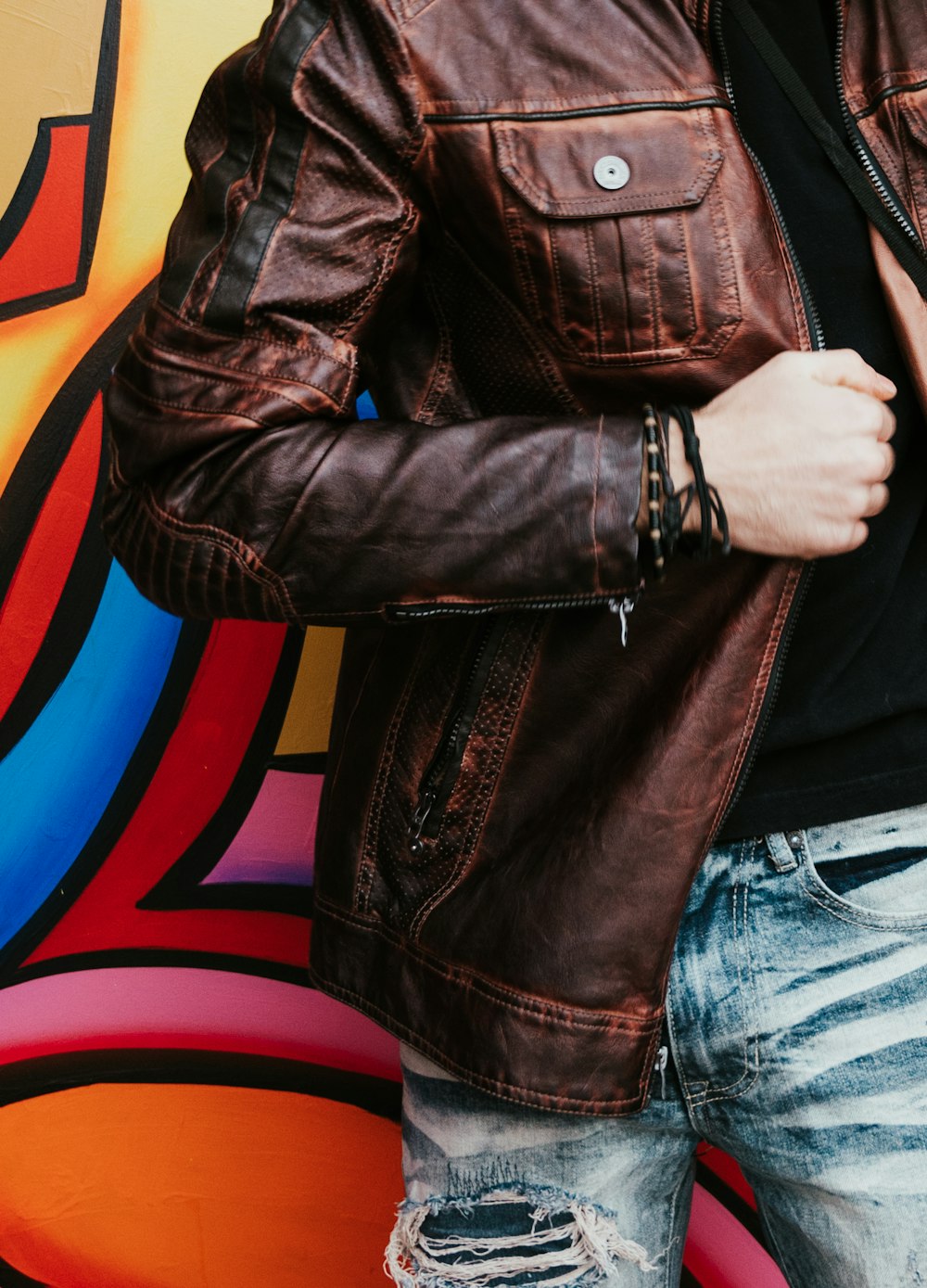 person in brown leather zip-up jacket