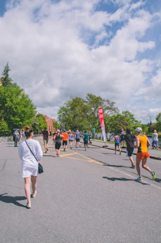 Volunteers handing out water at a community charity run event on a sunny day.