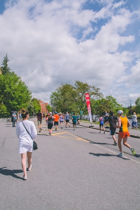 Runners crossing the starting line at the Steps for Hope 5K event on a sunny day.
