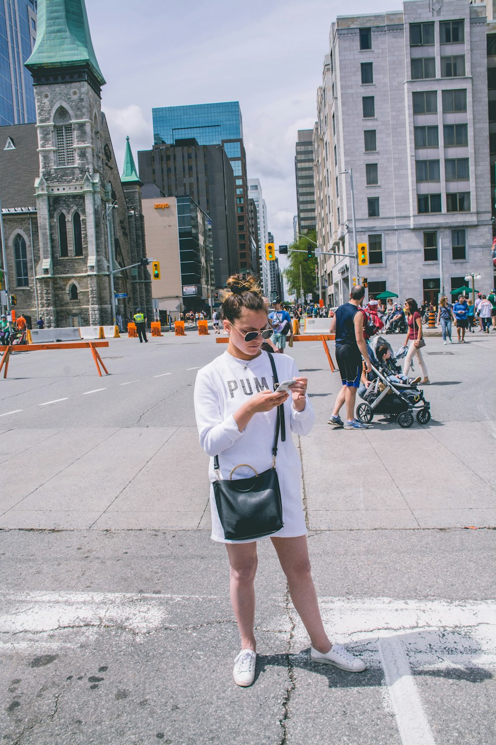woman using smartphone on sidewalk