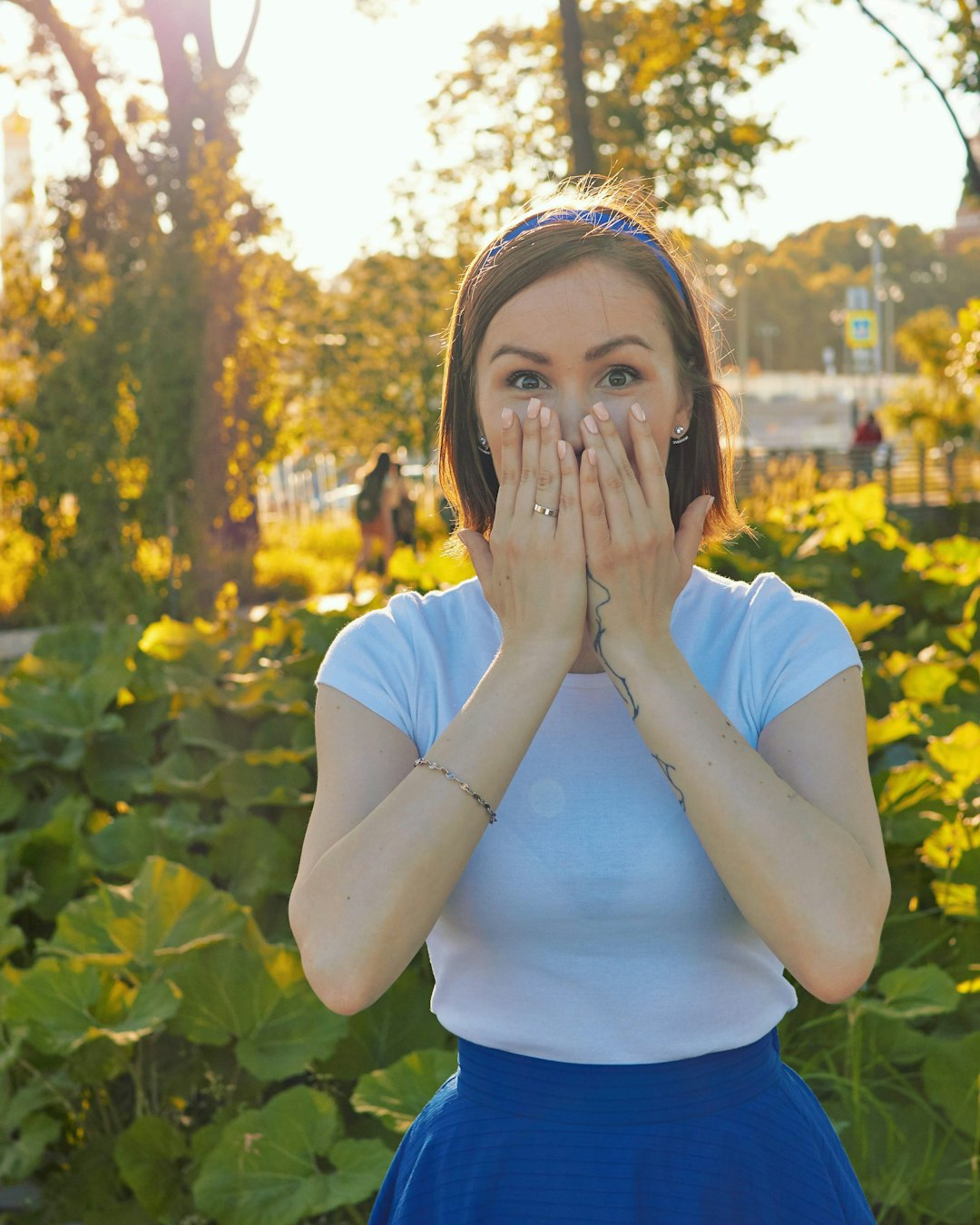 Woman with shocked look on her face, and her hands over her mouth