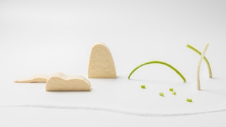 Colorful 3D printed geometric shapes arranged neatly on a minimalist white background.