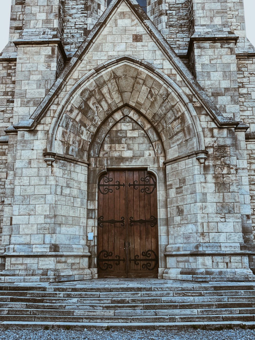 a large stone building with a wooden door