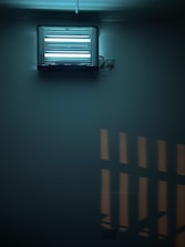 A modern insect killer device mounted on a wall in a clean, bright room.