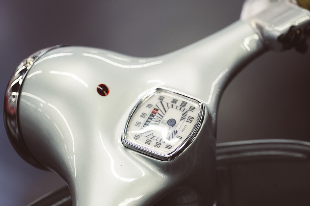 classic white motor scooter handlebar with speedometer