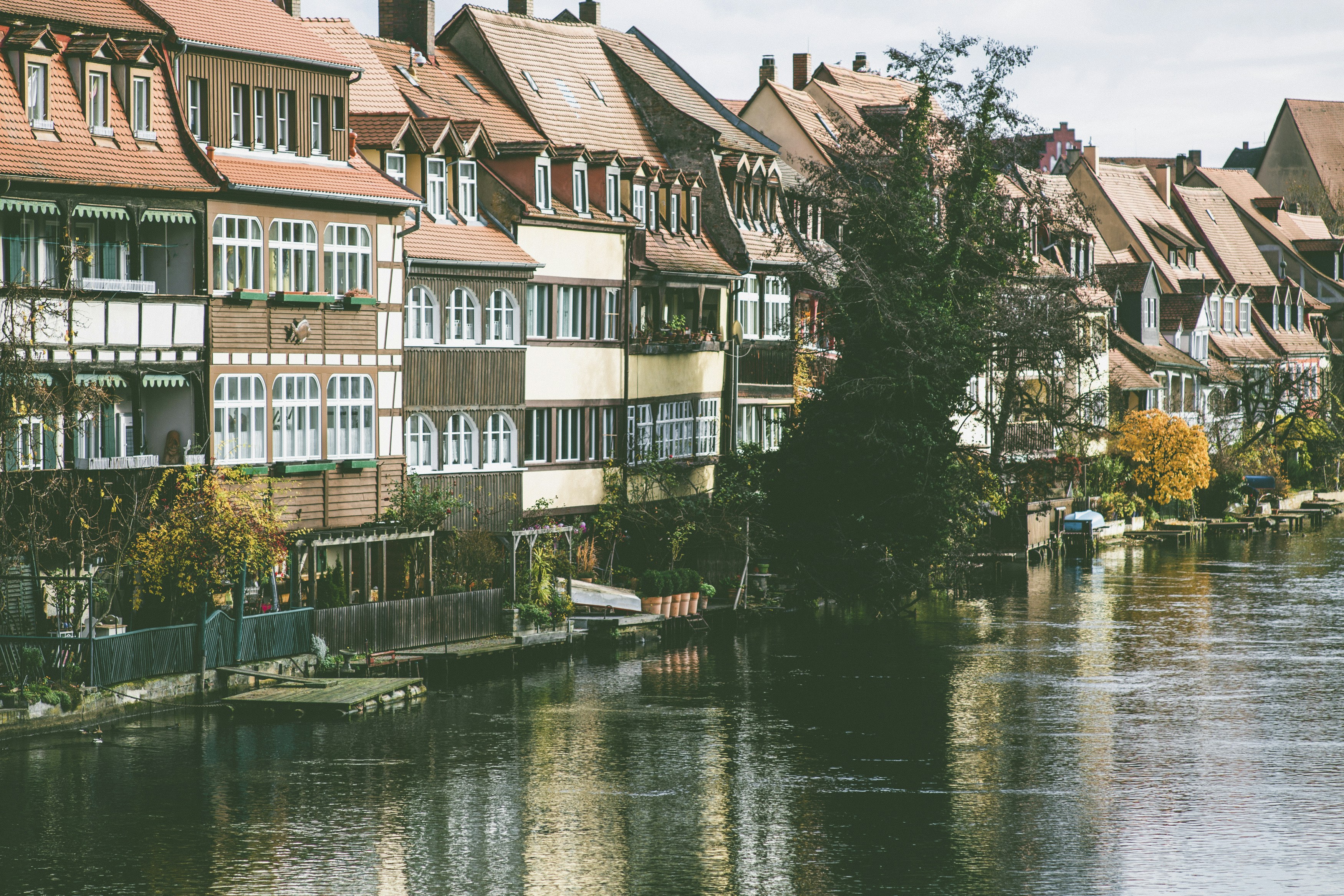 line of buildings beside body of water during day