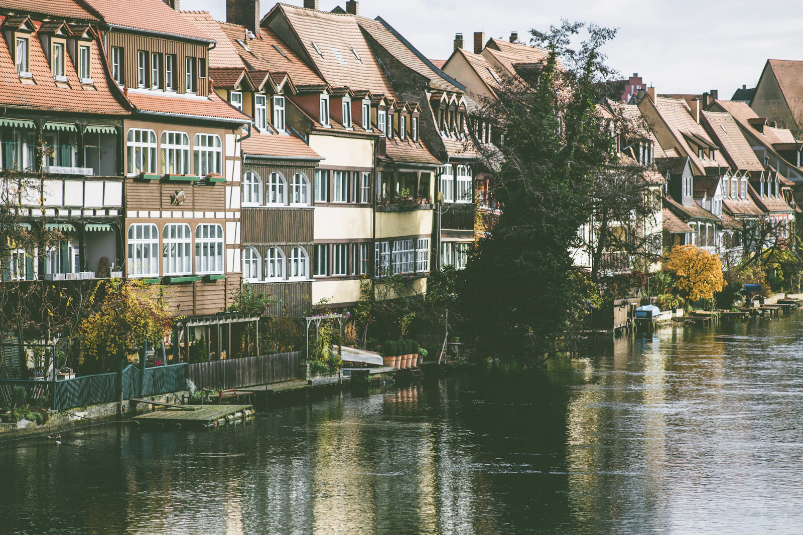 line of buildings beside body of water during day