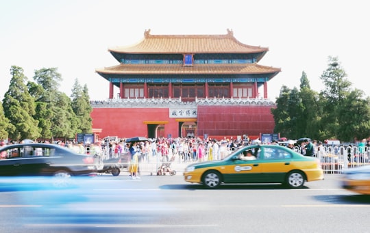 yellow and black sedan running on the road in The Palace Museum China