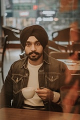 Paras Singh enjoying a coffee break with friends in a cozy café.